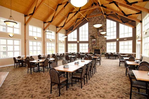 Spacious dining area with tables and chairs in a senior living facility