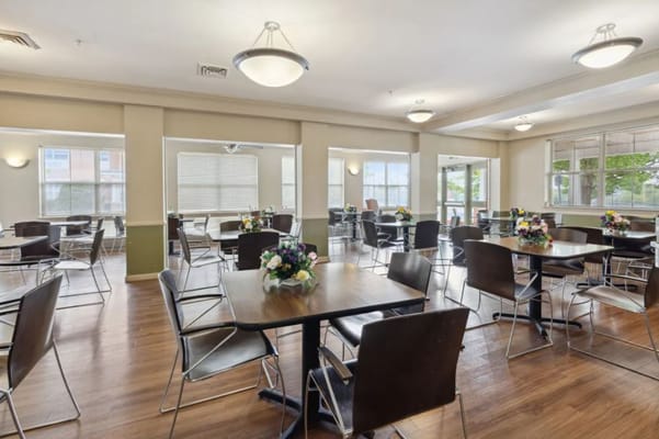 Interior view of a dining area with tables and flowers