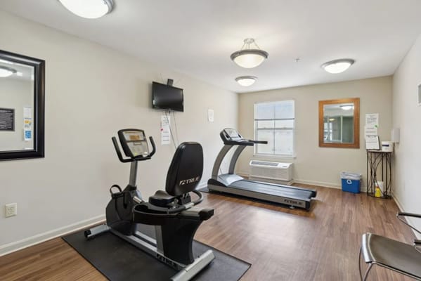 Fitness room with exercise equipment and mirror