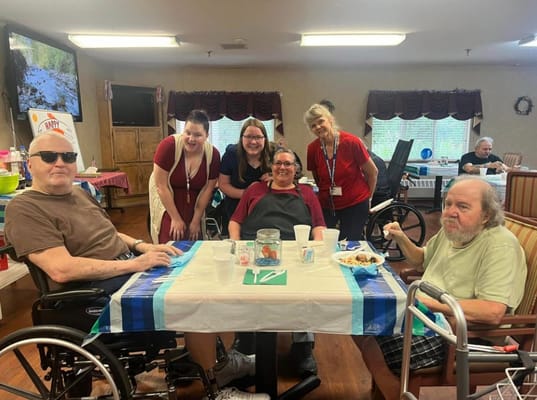 Residents and staff enjoying a meal together