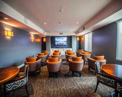 A cozy common area with seating and a TV