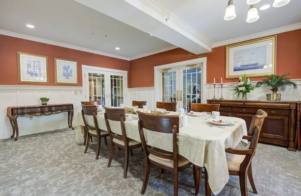 A beautifully set dining room with a table and chairs