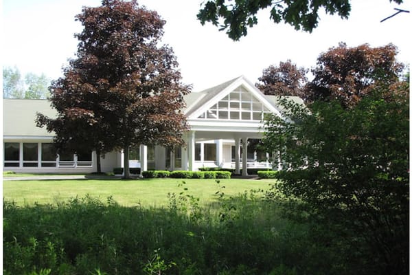 Exterior view of a senior living facility with trees