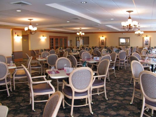 Dining area with tables and chairs set up for meals