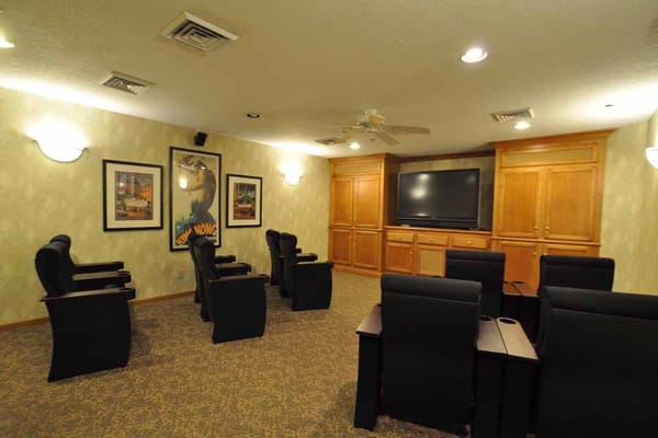 Cozy media room with seating and large screen TV