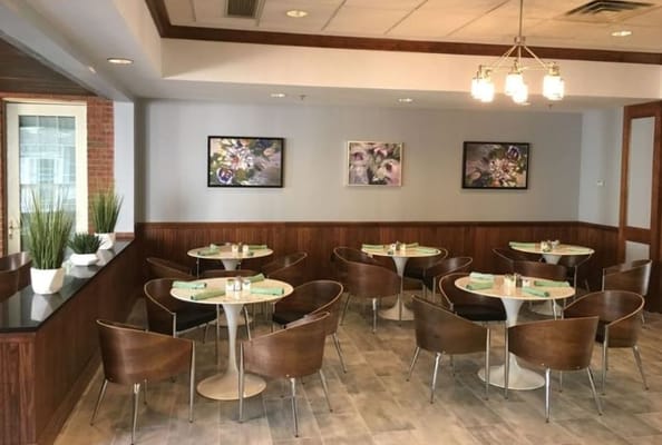 Bright dining area with modern furniture and artwork