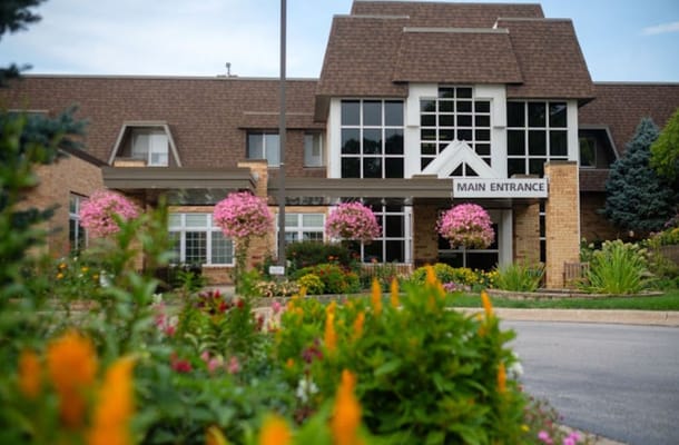 Main entrance of Friendship Manor with beautiful flowers