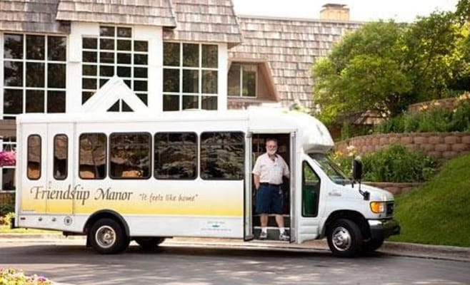 Facility transport bus with a staff member