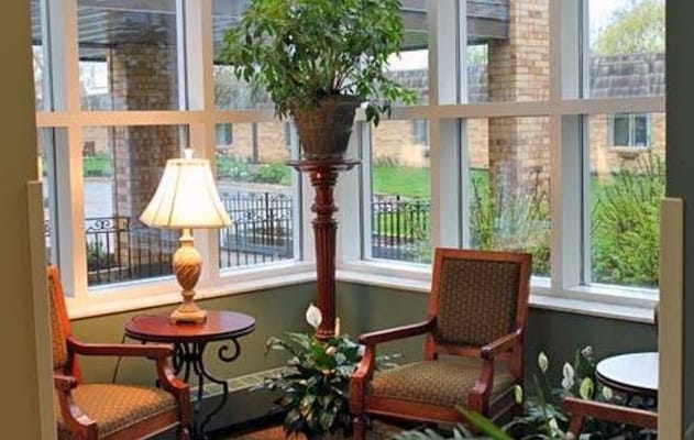 Bright indoor lounge area with plants and seating