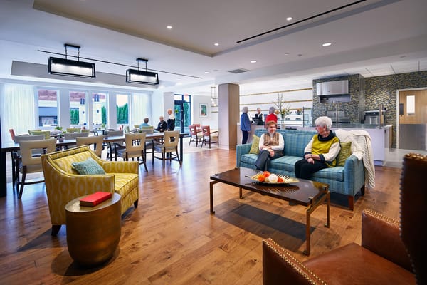 Residents enjoying a common area with seating and decor