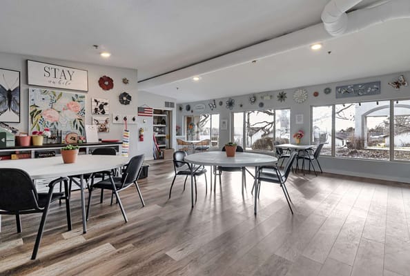 Bright common area with tables and wall decor
