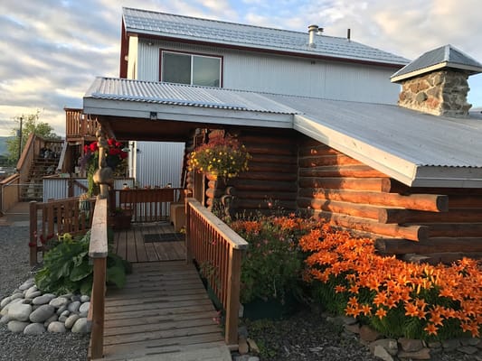 Exterior view of a facility with flowers and wooden entrance