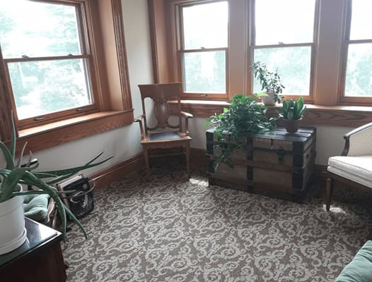 Cozy sitting area with plants and windows