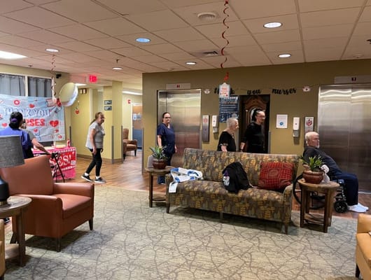 Residents and staff interacting in the lobby area of Granite Rehabilitation and Wellness