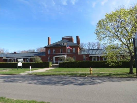 Exterior view of a nursing home facility with an American flag