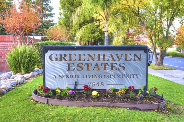 Sign for Greenhaven Estates senior living community with landscaping