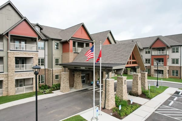 Exterior view of Harmony at Bellevue entrance with flags