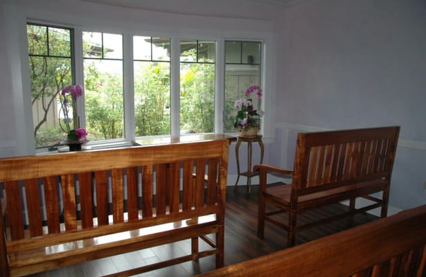 Seating area with large windows and plants
