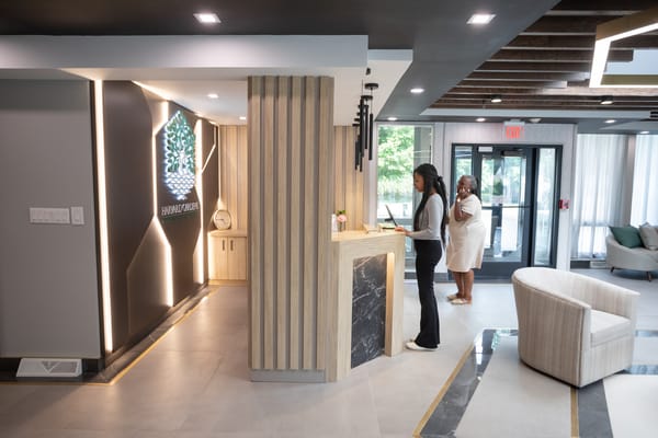 Staff assisting residents at an interior reception area