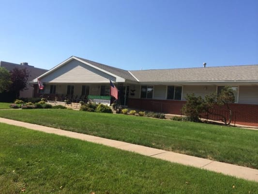 Exterior view of Havelock Manor with green lawn and flags