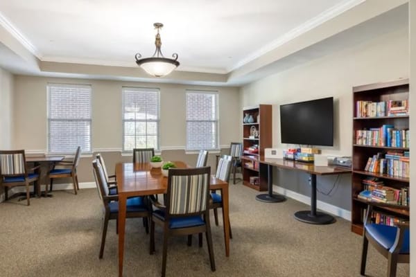 Common area with tables and seating in a bright room