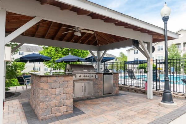 Outdoor barbecue area next to a swimming pool