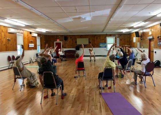 Residents participating in an exercise class in an activity room