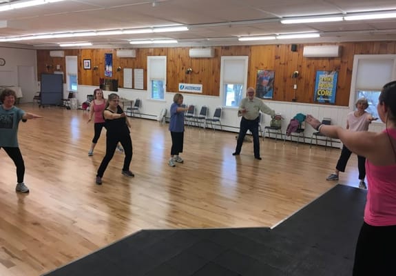 Residents participating in a group exercise class indoors