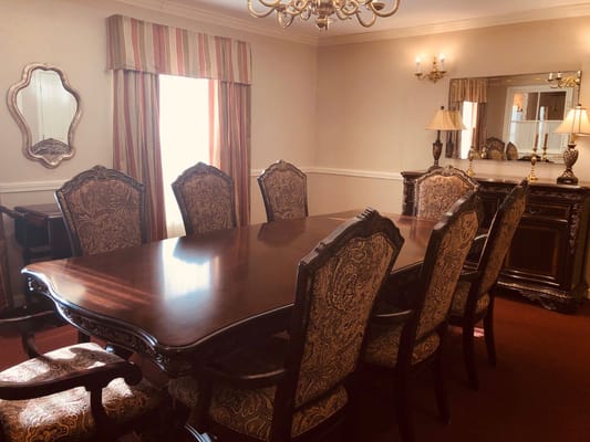 Dining room with a wooden table and ornate chairs