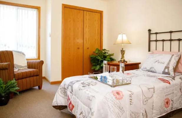 Cozy resident room with bed and seating area