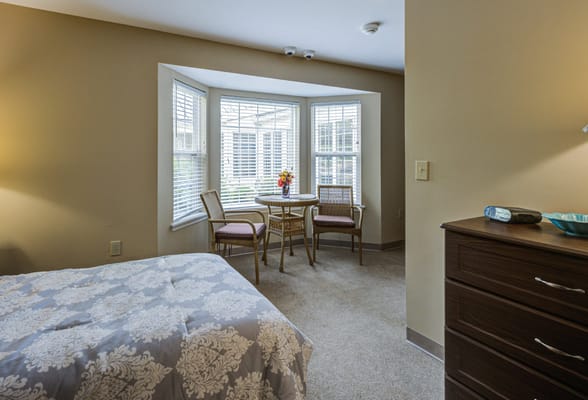 Cozy resident room with a sitting area and sunny window