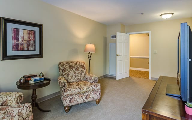 Cozy resident room with chairs and a lamp