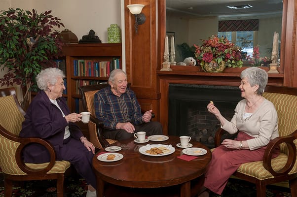 Residents enjoying refreshments in a cozy common area
