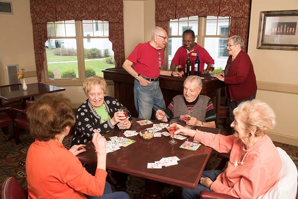 Residents enjoying a game of cards in a common area