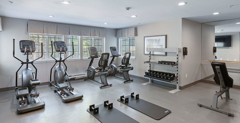 Modern fitness center equipped with exercise machines and weights