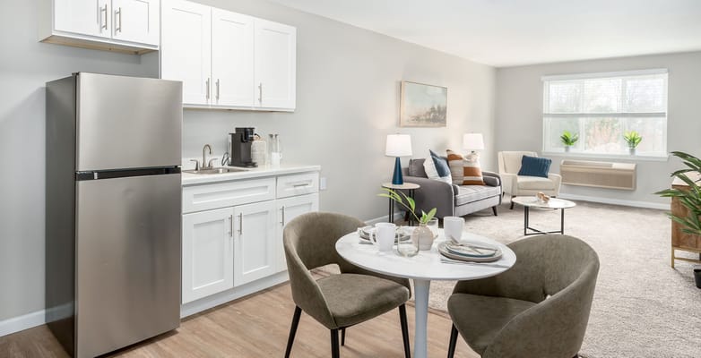 A cozy kitchen and living area with modern furniture.