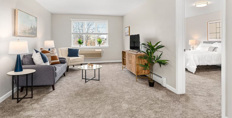 Cozy living room with a sofa, coffee table, and TV in Solista Charlotte