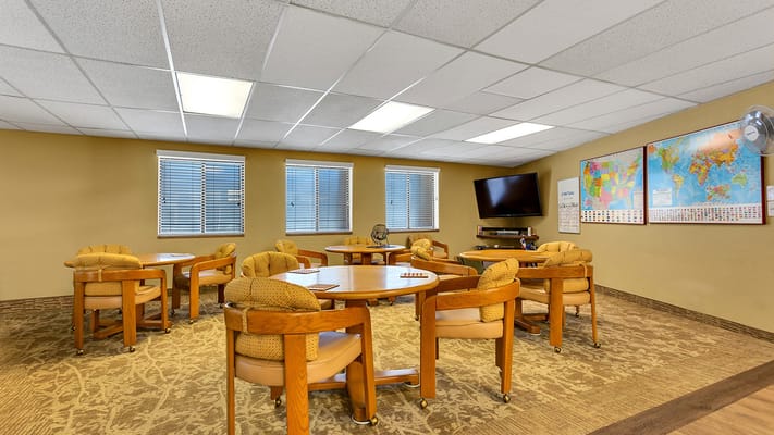 Bright activity room with tables and chairs