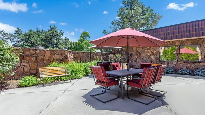 Outdoor seating area with shaded table and chairs