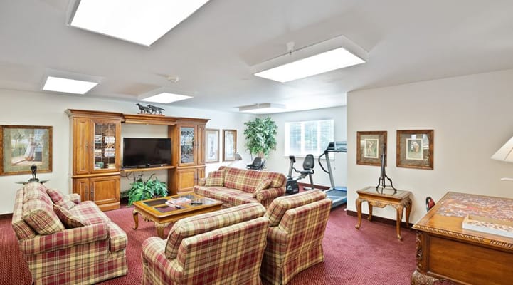 Cozy common area with seating and exercise equipment