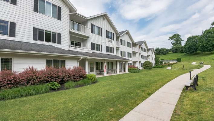 Exterior view of the assisted living facility with landscaped gardens
