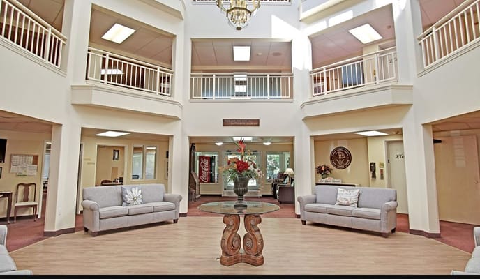 Bright entry lobby with seating and floral centerpiece