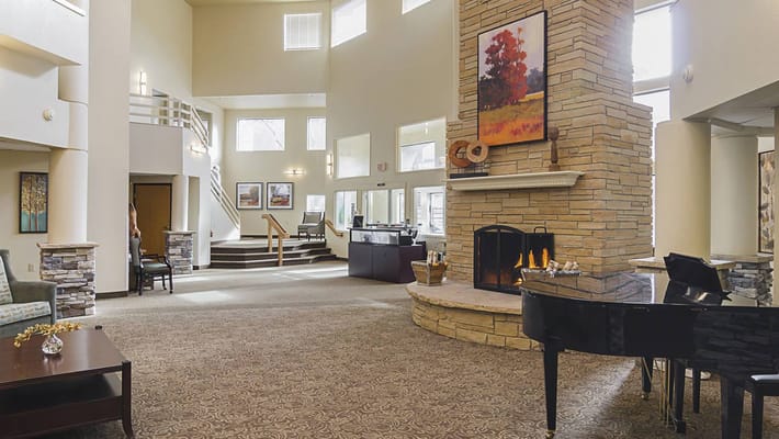 Bright, spacious lobby area with fireplace and seating