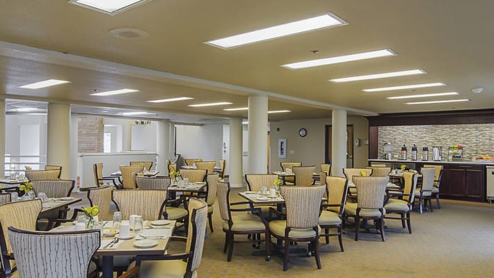 Dining area with tables set for residents