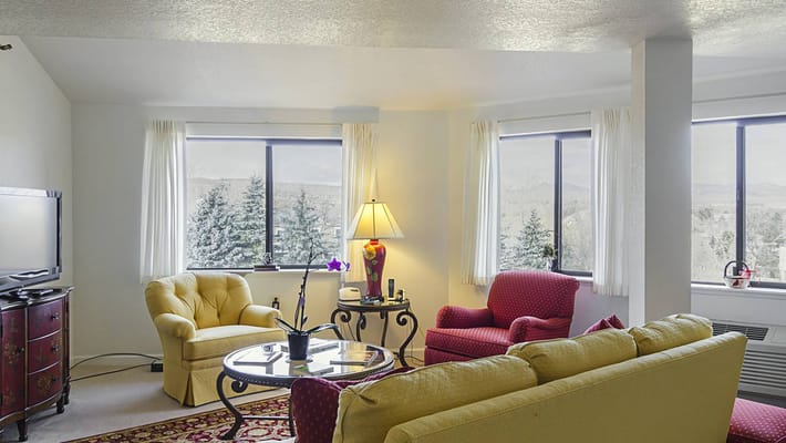 Bright interior living area with seating and windows