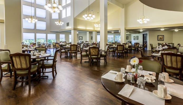 Spacious dining room with tables set for meals