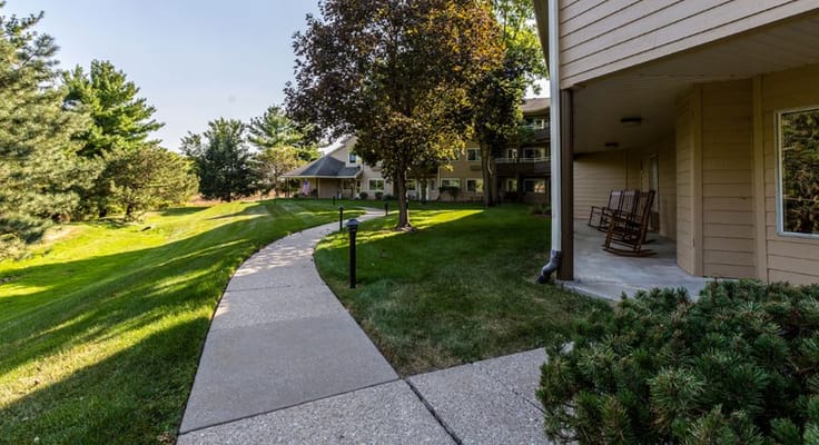 Pathway leading to outdoor green areas with seating