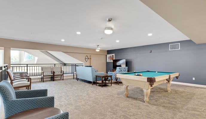 Interior lounge area with a pool table and seating