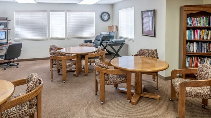 Bright common area with tables and bookshelves