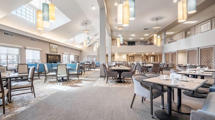 Bright dining room with tables set for meals